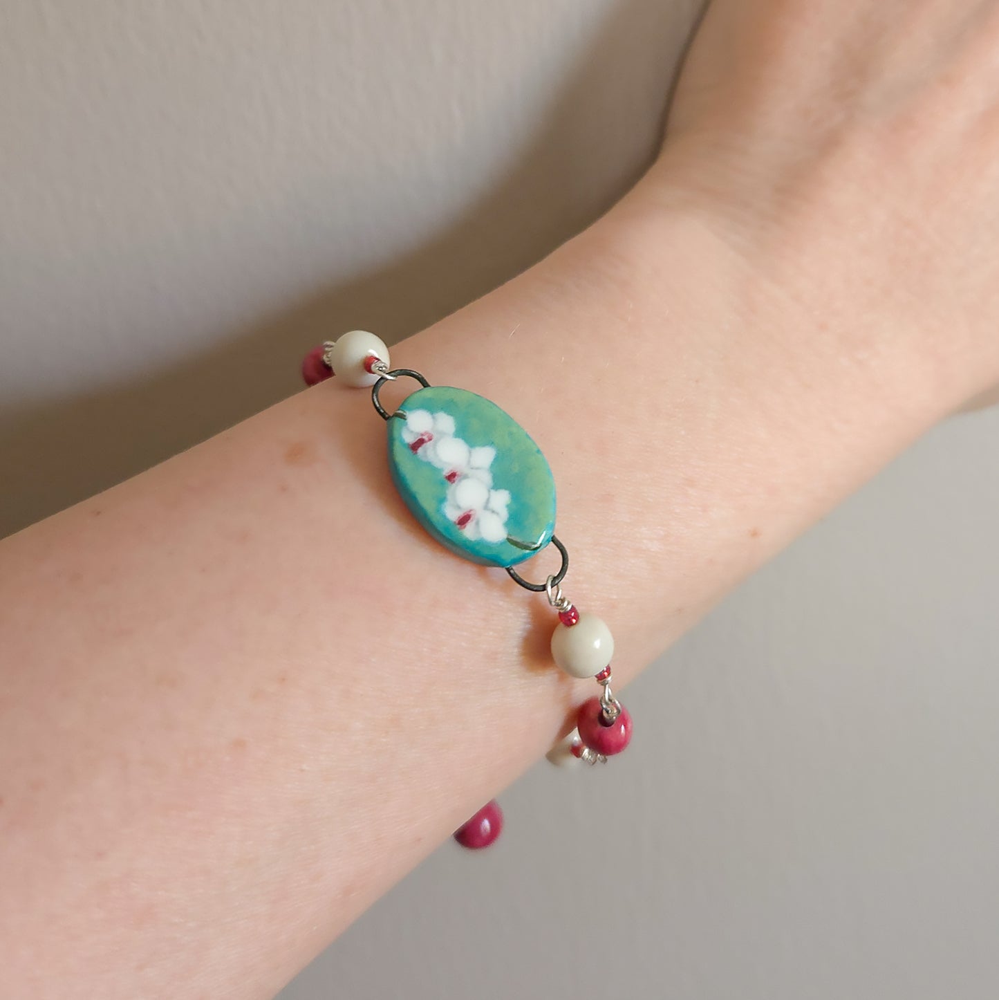 Orchid bracelet is shown on a model's arm/wrist.