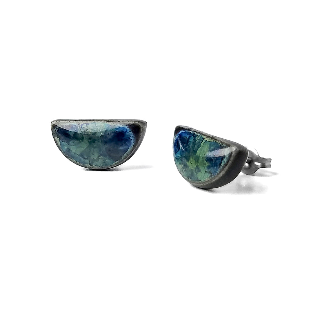Half Moon earrings in shades of blue and green sit on a white background.